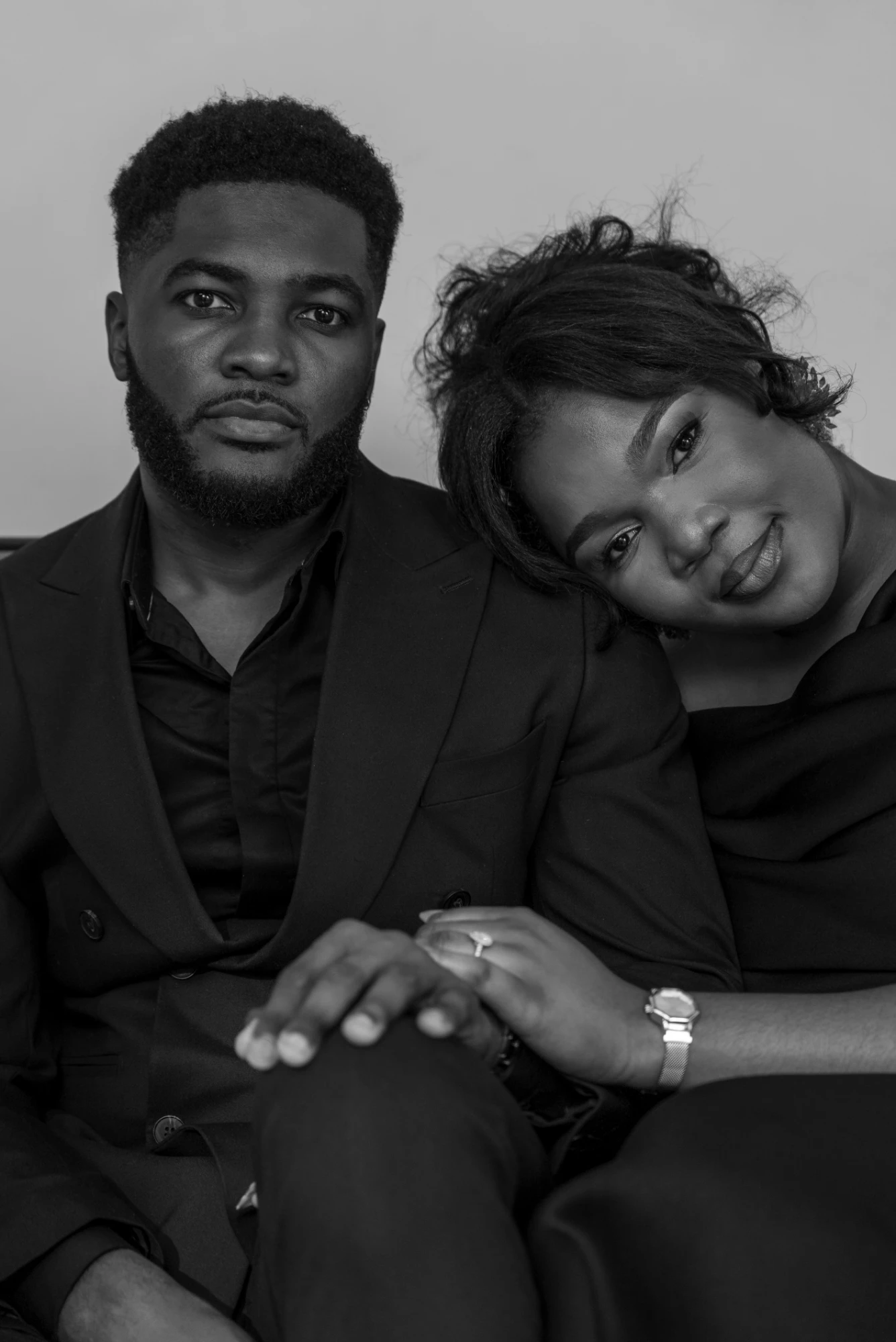 Engaged couple seated together, black and white portrait